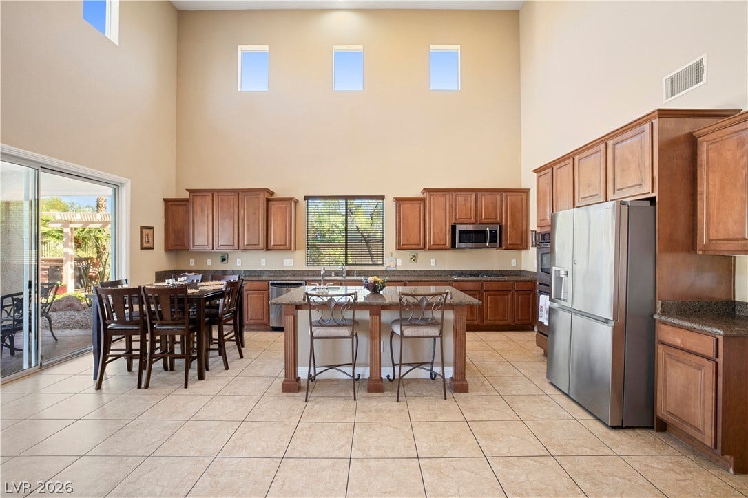 926 Loma Bonita Place, Las Vegas, NV 89138 Towering ceilings and sliding glass doors enhance this well-appointed culinary space with tile flooring.