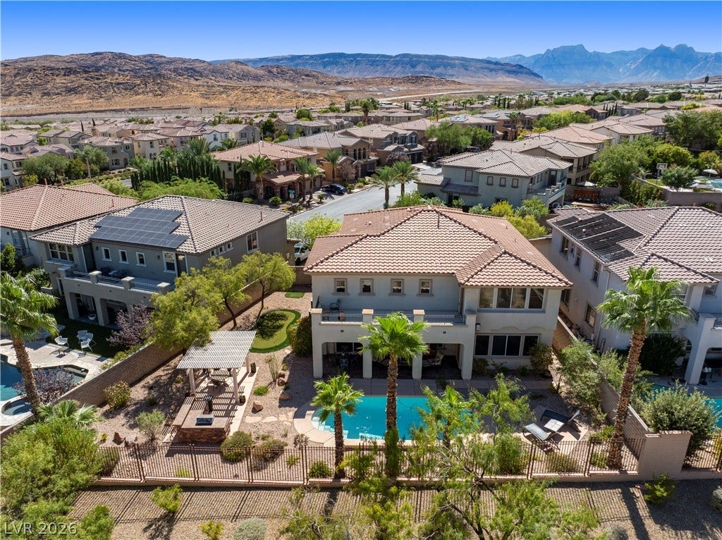 926 Loma Bonita Place, Las Vegas, NV 89138 An inviting backyard oasis captures majestic mountain vistas beyond a sparkling pool and manicured lawn.
