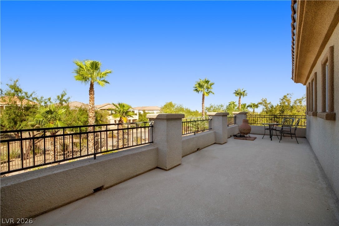 926 Loma Bonita Place, Las Vegas, NV 89138 An elevated stone terrace overlooks a scenic desert landscape dotted with mature palm trees.