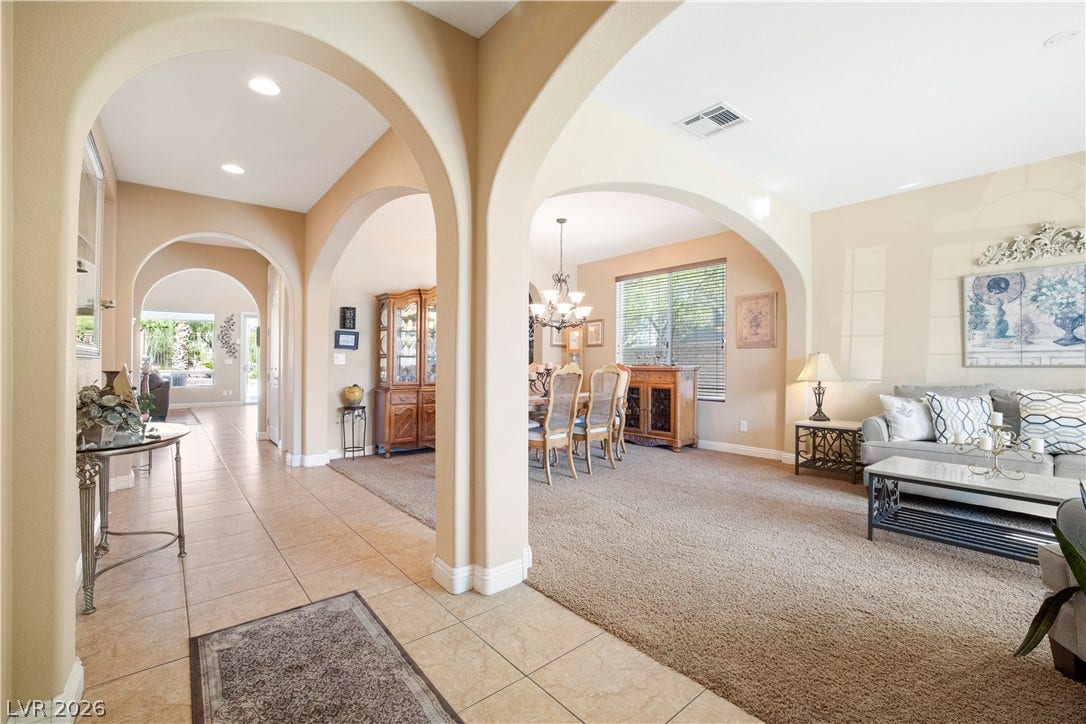 926 Loma Bonita Place, Las Vegas, NV 89138 Elegant arched transitions frame the open layout connecting the main living areas.