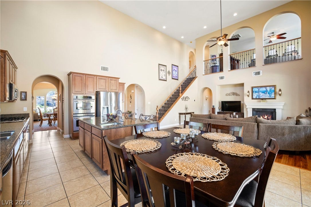 926 Loma Bonita Place, Las Vegas, NV 89138 Dramatic high ceilings and a central staircase anchor this expansive open-concept living area.