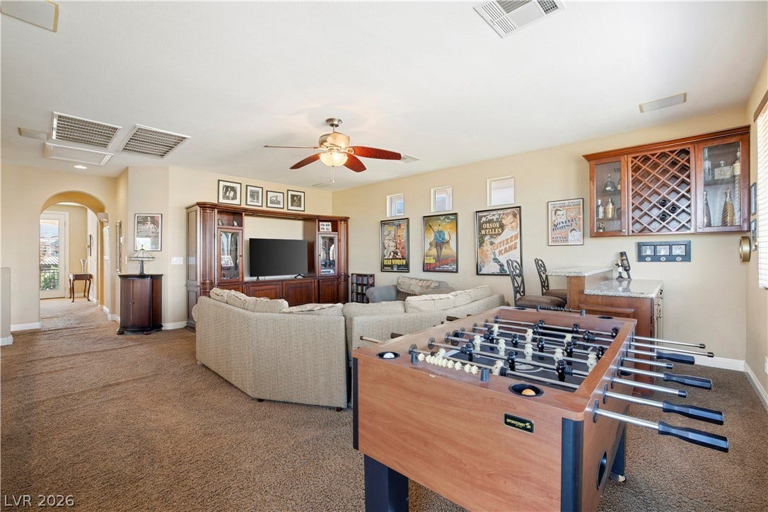 926 Loma Bonita Place, Las Vegas, NV 89138 Plush carpeting anchors this versatile recreation room complete with a built-in wet bar.