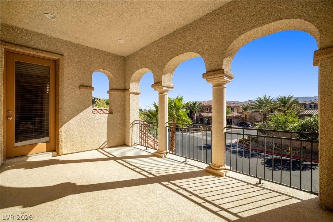 926 Loma Bonita Place, Las Vegas, NV 89138 Stately arched columns frame a covered balcony overlooking the quiet neighborhood street.
