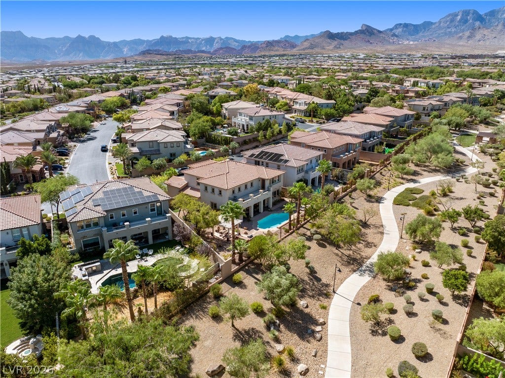 926 Loma Bonita Place, Las Vegas, NV 89138 A picturesque neighborhood pathway winds below majestic desert mountains framing the horizon.