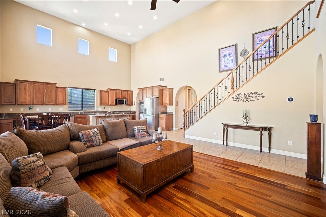 926 Loma Bonita Place, Las Vegas, NV 89138 Warm hardwood floors and towering ceilings define this open, light-filled living area.