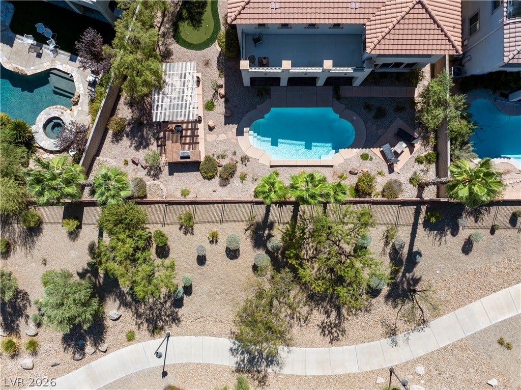 926 Loma Bonita Place, Las Vegas, NV 89138 An aerial perspective reveals a beautifully landscaped backyard featuring a private pool and pergola.