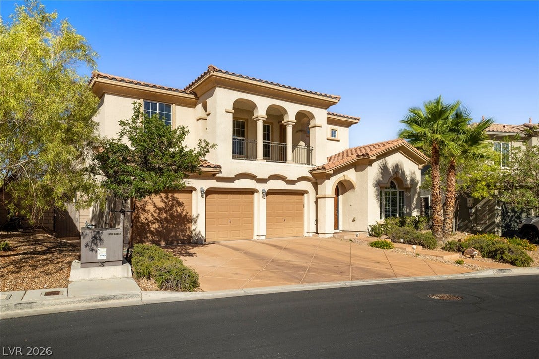 926 Loma Bonita Place, Las Vegas, NV 89138 Mediterranean architectural details and an arched balcony elevate this elegant multi-level exterior design.
