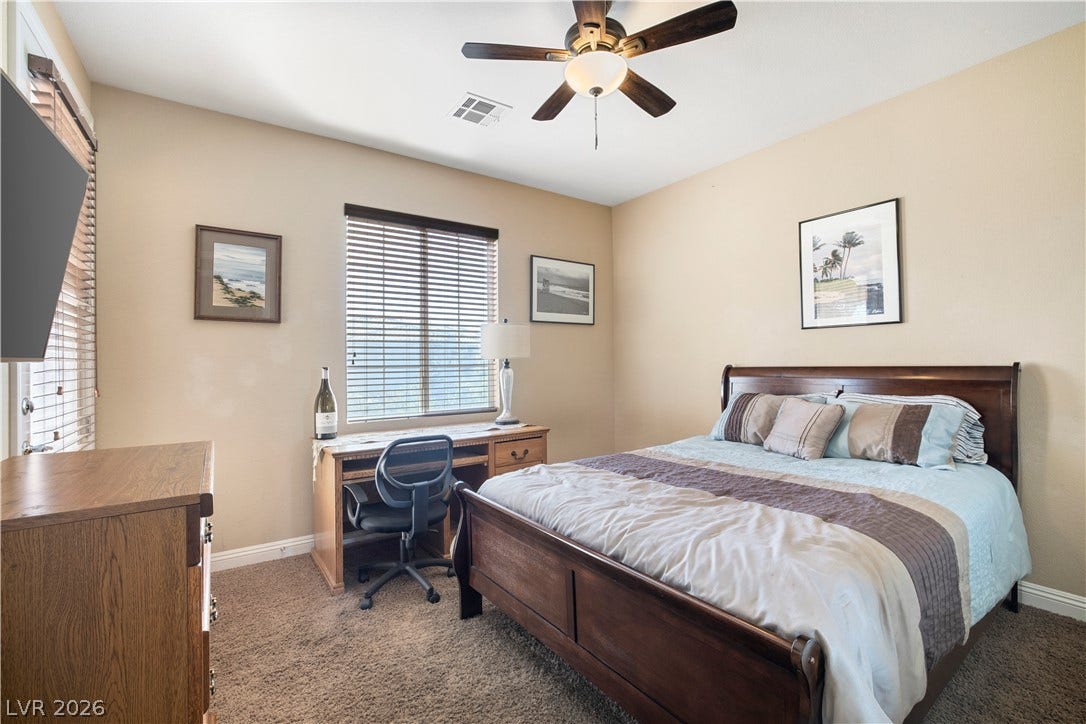 926 Loma Bonita Place, Las Vegas, NV 89138 Plush carpeting and abundant natural light create a welcoming atmosphere in this spacious bedroom.