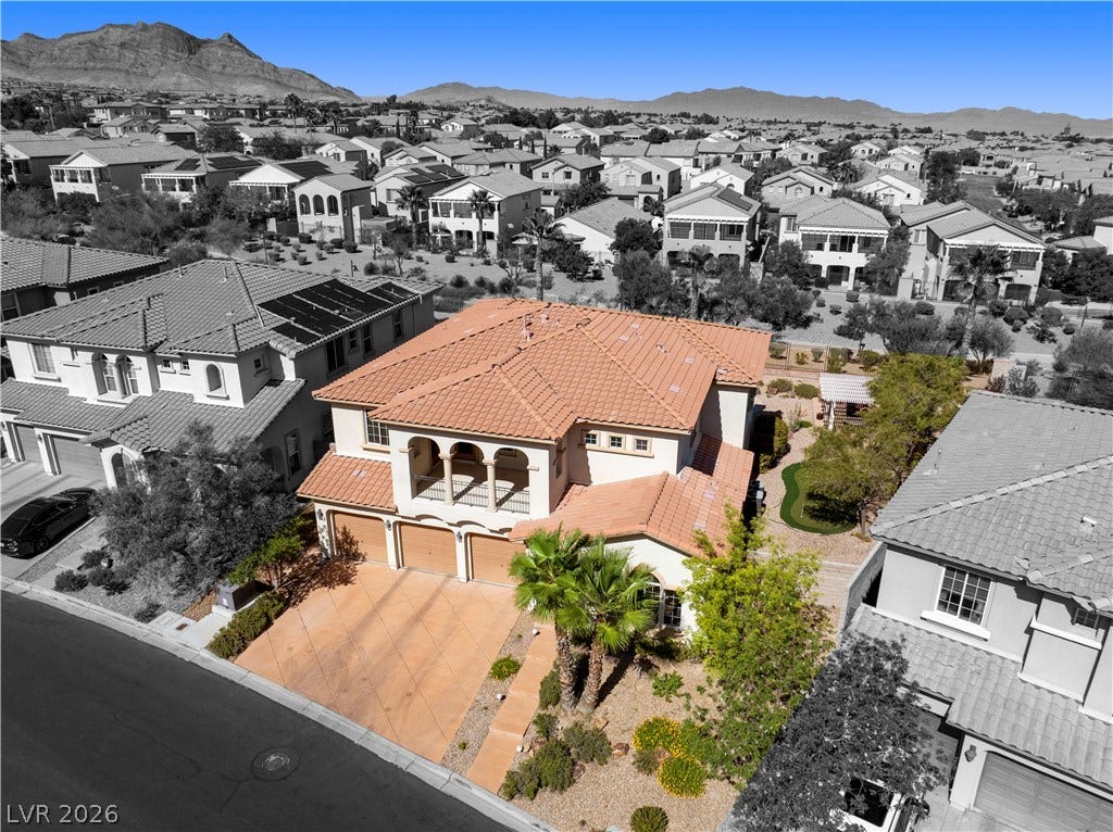 926 Loma Bonita Place, Las Vegas, NV 89138 An aerial perspective reveals a two-story home with a clay tile roof and concrete driveway.