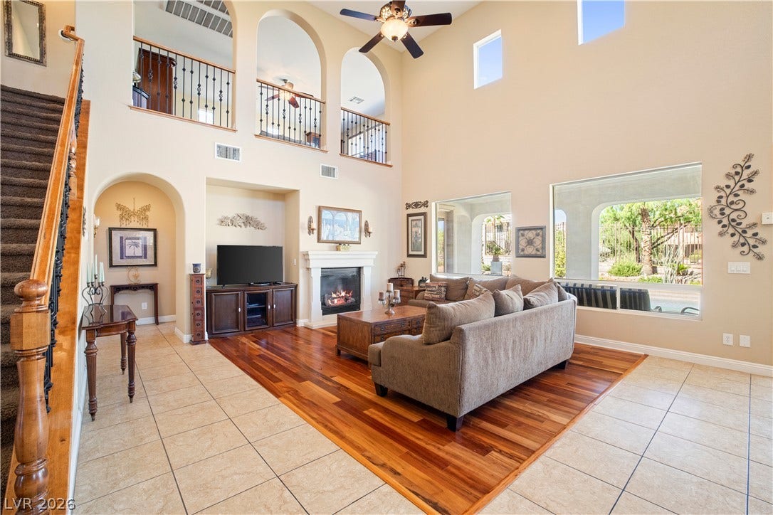 926 Loma Bonita Place, Las Vegas, NV 89138 Towering ceilings and mixed flooring enhance the architectural interest of this grand living area.