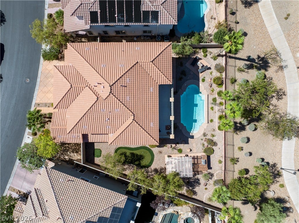 926 Loma Bonita Place, Las Vegas, NV 89138 An aerial perspective showcases the tiled rooflines, private swimming pool, and desert landscaping.