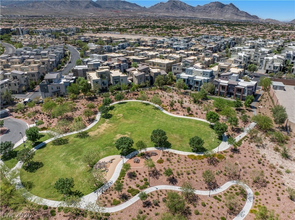 926 Loma Bonita Place, Las Vegas, NV 89138 Lush neighborhood park with winding paved paths offers a green oasis against a mountain backdrop.