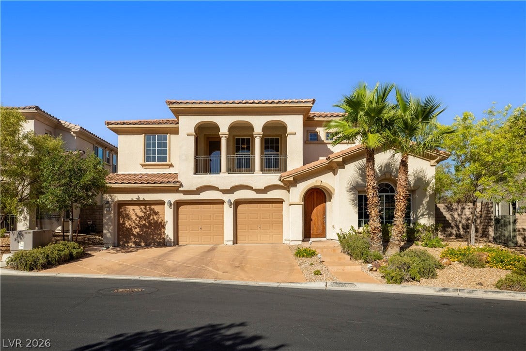 926 Loma Bonita Place, Las Vegas, NV 89138 Elegant Spanish-style architecture highlights this multi-level home featuring an arched balcony and a three-car garage.