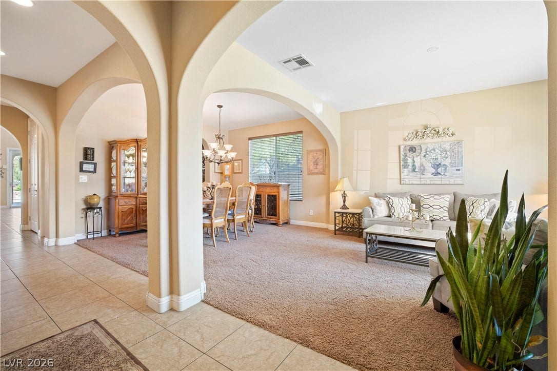 926 Loma Bonita Place, Las Vegas, NV 89138 Stately arched openings connect the tiled entryway directly to the carpeted formal living spaces.