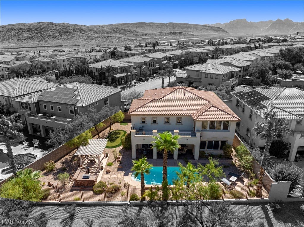 926 Loma Bonita Place, Las Vegas, NV 89138 A terracotta tile roof accents this elegant desert residence overlooking a private backyard pool.