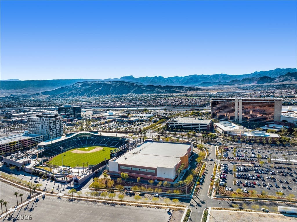 926 Loma Bonita Place, Las Vegas, NV 89138 Dramatic mountain ranges frame a sprawling landscape of sports facilities and urban developments.