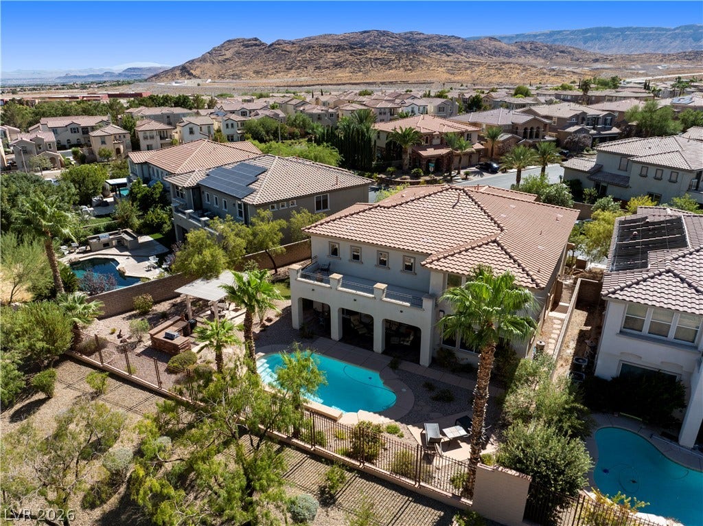 926 Loma Bonita Place, Las Vegas, NV 89138 Desert mountains frame this multi-level community featuring tile roofs and private backyard swimming pools.
