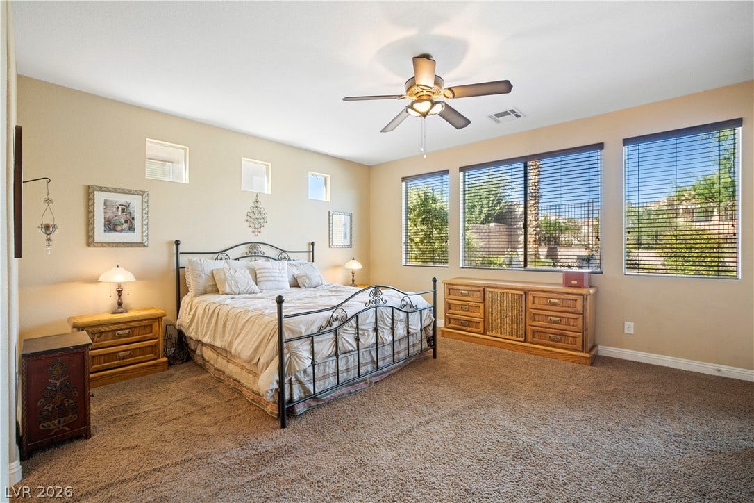 926 Loma Bonita Place, Las Vegas, NV 89138 Plentiful natural light streams through multiple windows highlighting the spacious bedroom layout.