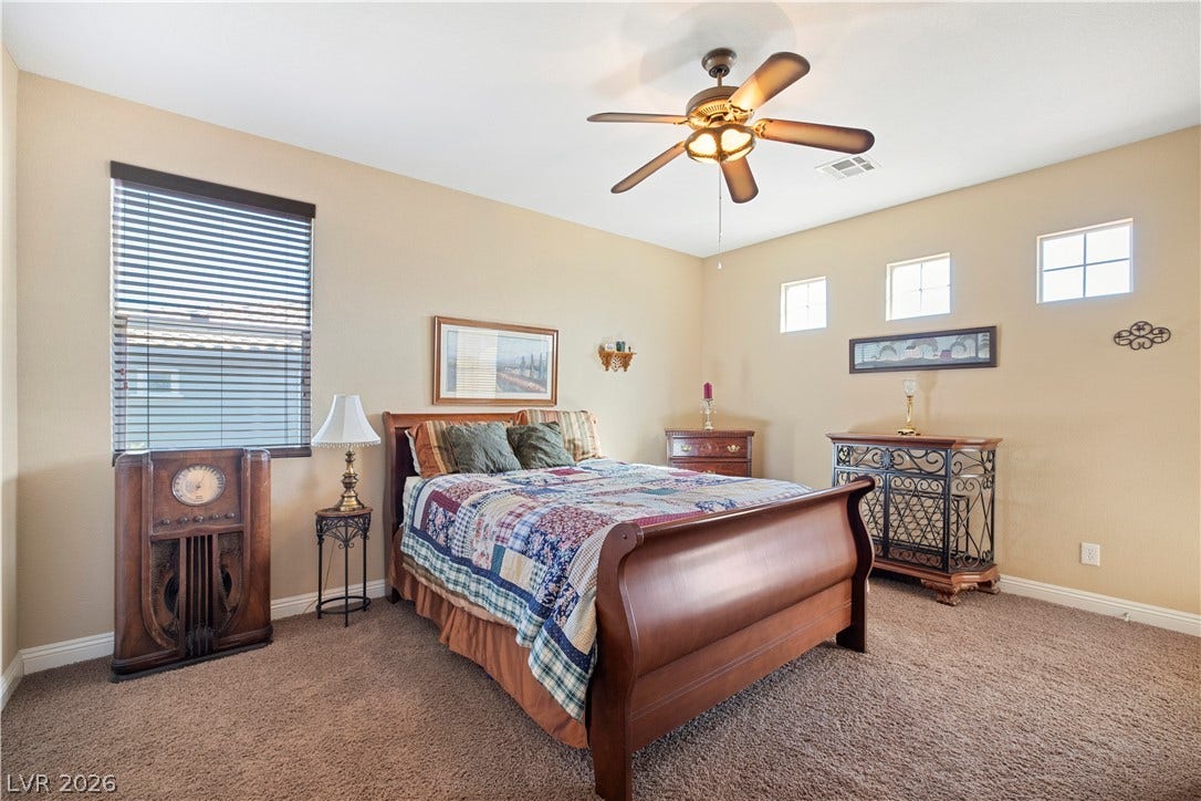 926 Loma Bonita Place, Las Vegas, NV 89138 Soft carpeting pairs with multi-pane accent windows in this comfortable sleeping space.