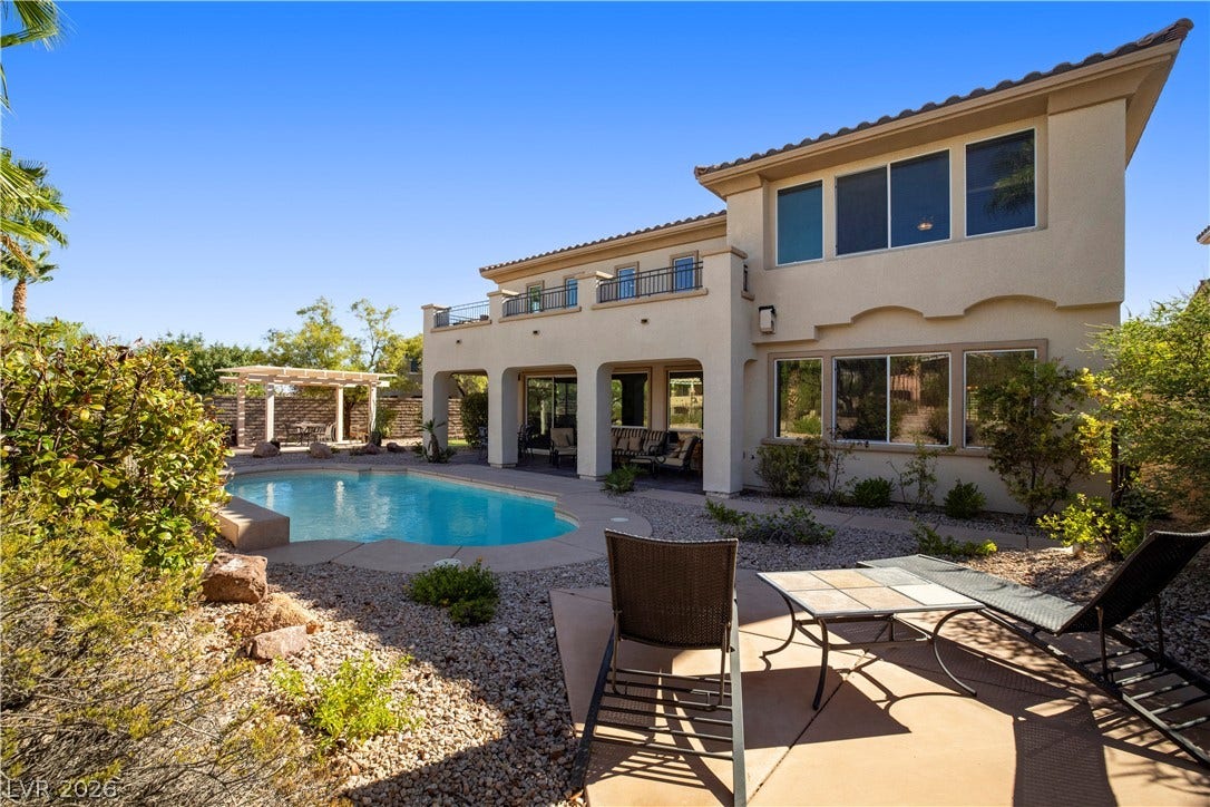 926 Loma Bonita Place, Las Vegas, NV 89138 A sparkling in-ground pool anchors this Mediterranean-style backyard featuring a covered patio and tile roof.
