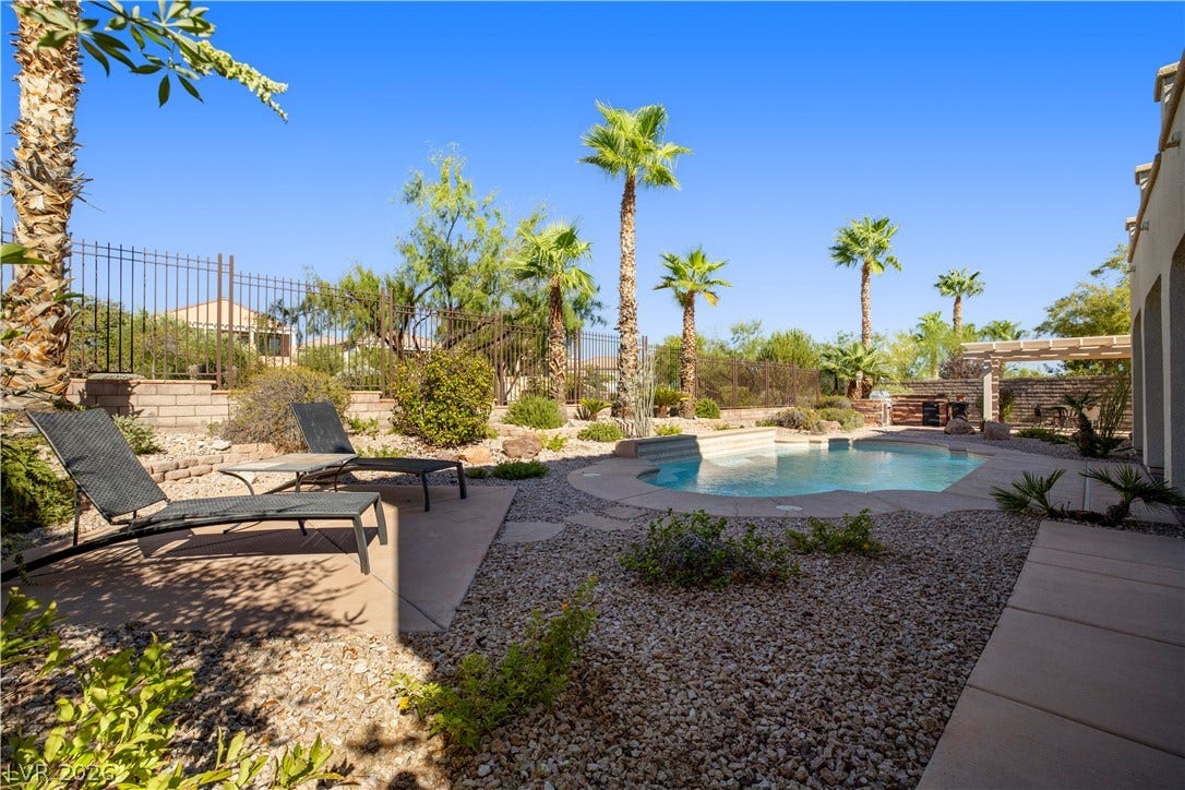 926 Loma Bonita Place, Las Vegas, NV 89138 Palm trees and desert landscaping frame a sparkling pool in this private backyard oasis.