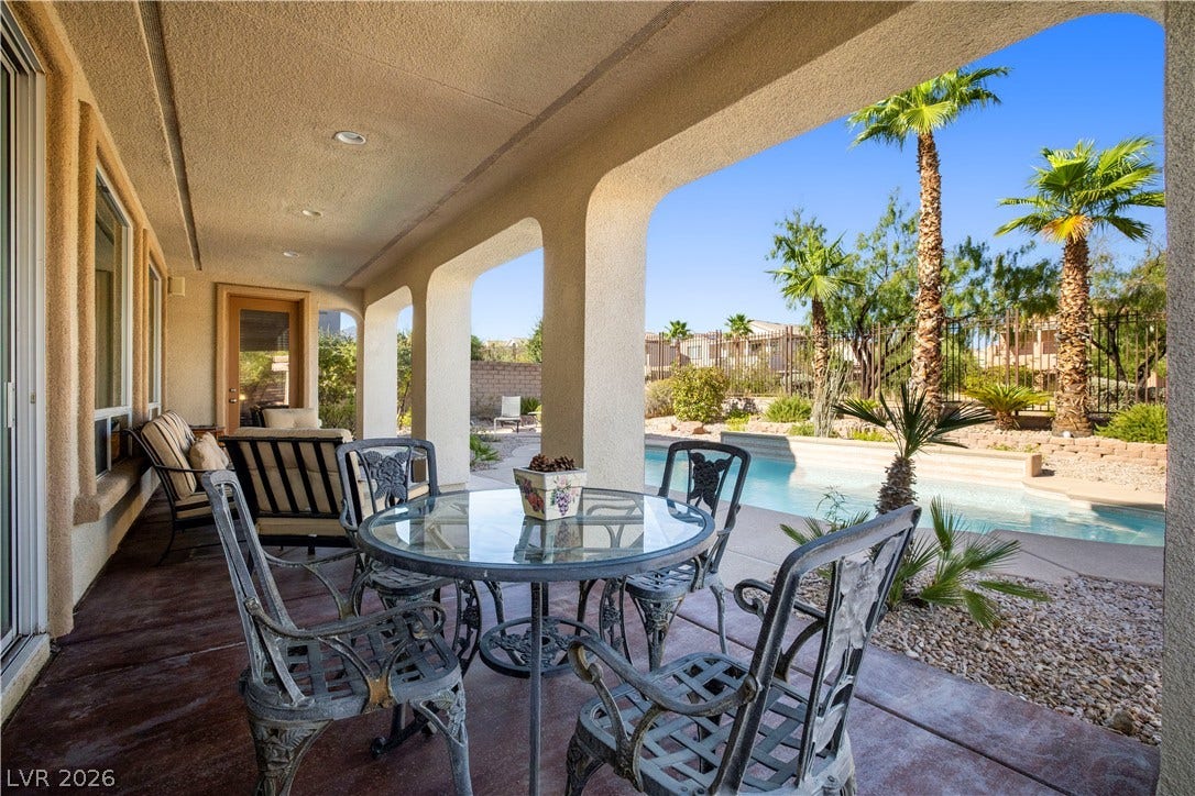 926 Loma Bonita Place, Las Vegas, NV 89138 A spacious covered patio overlooks the sparkling swimming pool and desert landscaping.