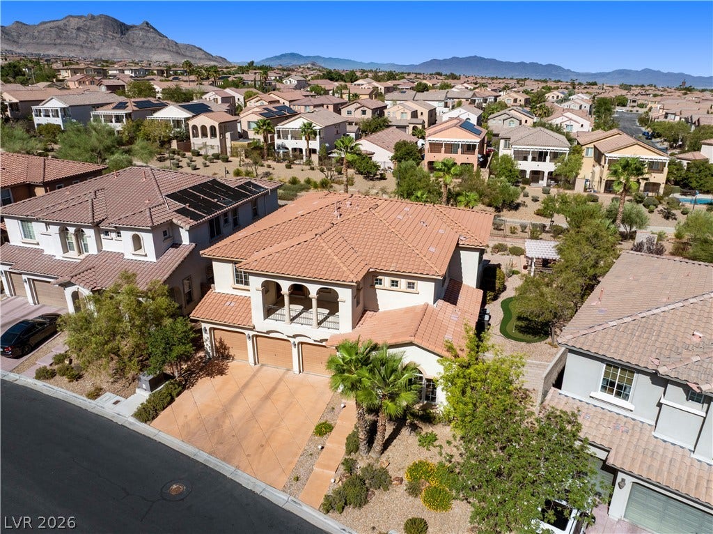 926 Loma Bonita Place, Las Vegas, NV 89138 Spanish tile roofs and paved driveways define this tranquil desert neighborhood under mountain backdrops.
