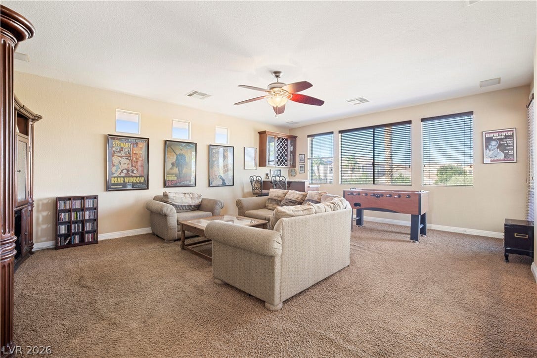 926 Loma Bonita Place, Las Vegas, NV 89138 Generous windows fill this versatile recreation room with abundant natural light.