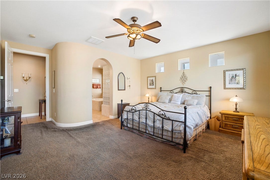 926 Loma Bonita Place, Las Vegas, NV 89138 An arched doorway leads to the master bathroom from this comfortable bedroom suite.