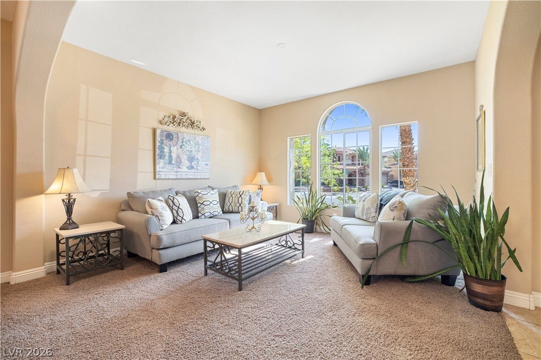 926 Loma Bonita Place, Las Vegas, NV 89138 Arched entryways frame a classic formal living space illuminated by towering arched windows.