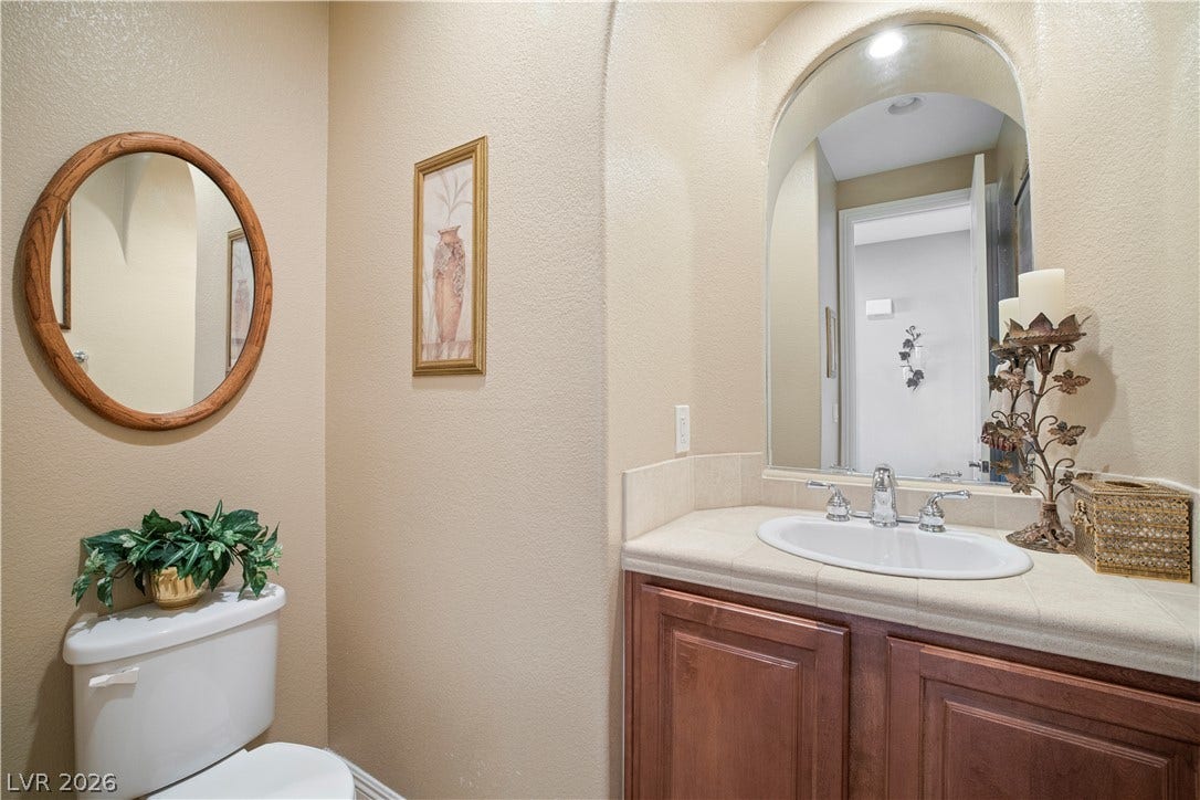 926 Loma Bonita Place, Las Vegas, NV 89138 An arched alcove frames the vanity area, creating classic architectural appeal in this powder room.