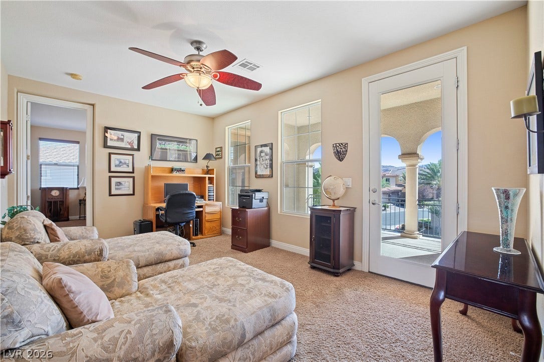 926 Loma Bonita Place, Las Vegas, NV 89138 Sunlight streams through tall windows and a glass door opening to a private balcony.