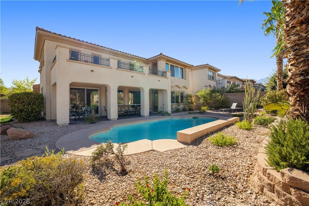 926 Loma Bonita Place, Las Vegas, NV 89138 An inviting backyard oasis features a shimmering private pool framed by desert-inspired landscaping.