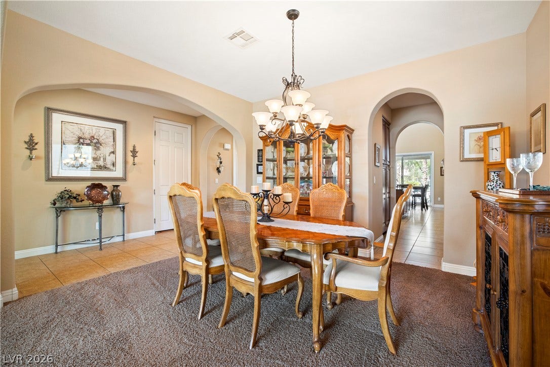 926 Loma Bonita Place, Las Vegas, NV 89138 Elegant arched doorways frame this formal dining area, highlighted by neutral flooring.