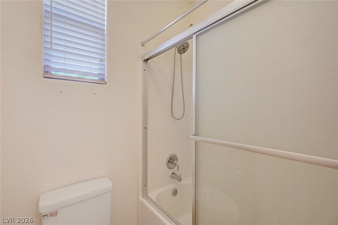 849 Ashford Way, Henderson, NV 89015 A well-appointed bathroom offers a convenient shower-tub combination and ample natural light.