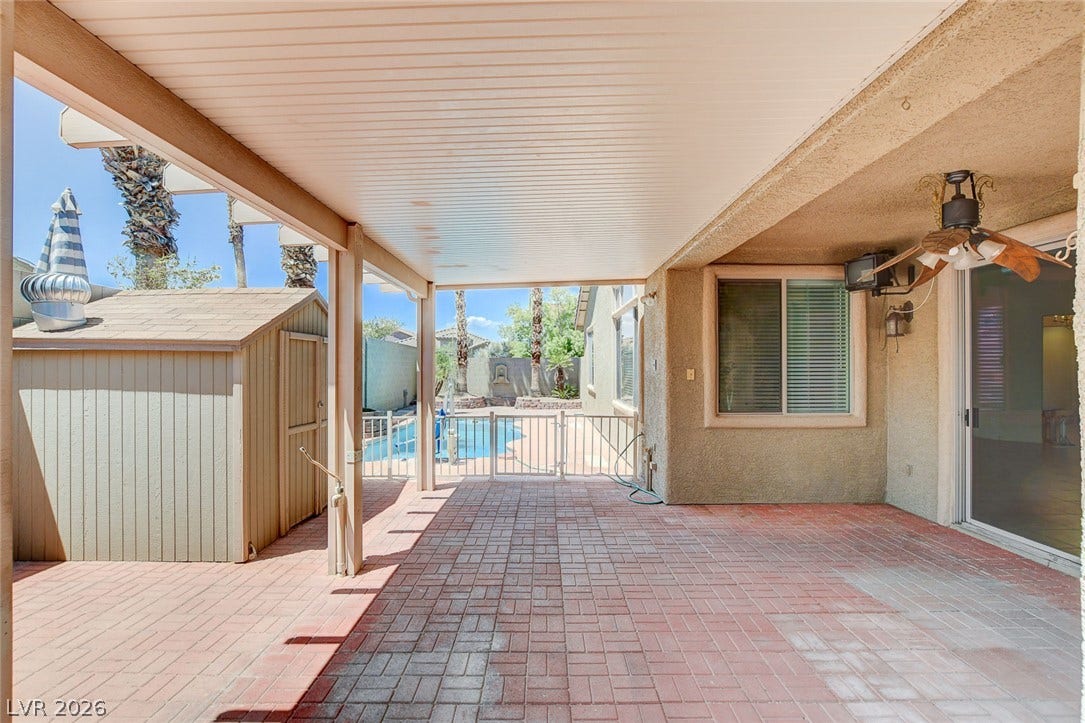 849 Ashford Way, Henderson, NV 89015 A well-appointed patio with brick pavers offers seamless transition to a private pool area, ideal for relaxation and entertaining.