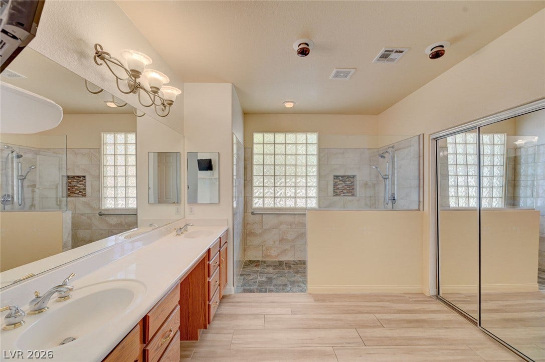 849 Ashford Way, Henderson, NV 89015 Double vanities and dual showers create a spa-like retreat in this spacious bathroom.