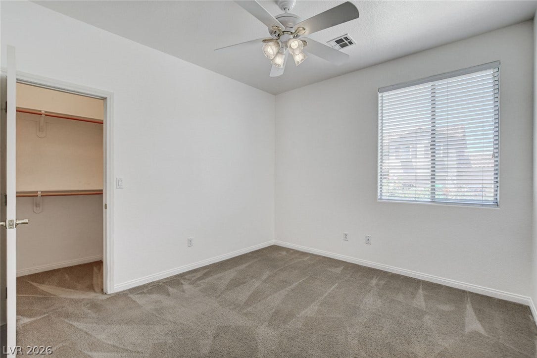 849 Ashford Way, Henderson, NV 89015 A well-lit bedroom provides ample space and comfort, featuring a ceiling fan and generous closet for storage.