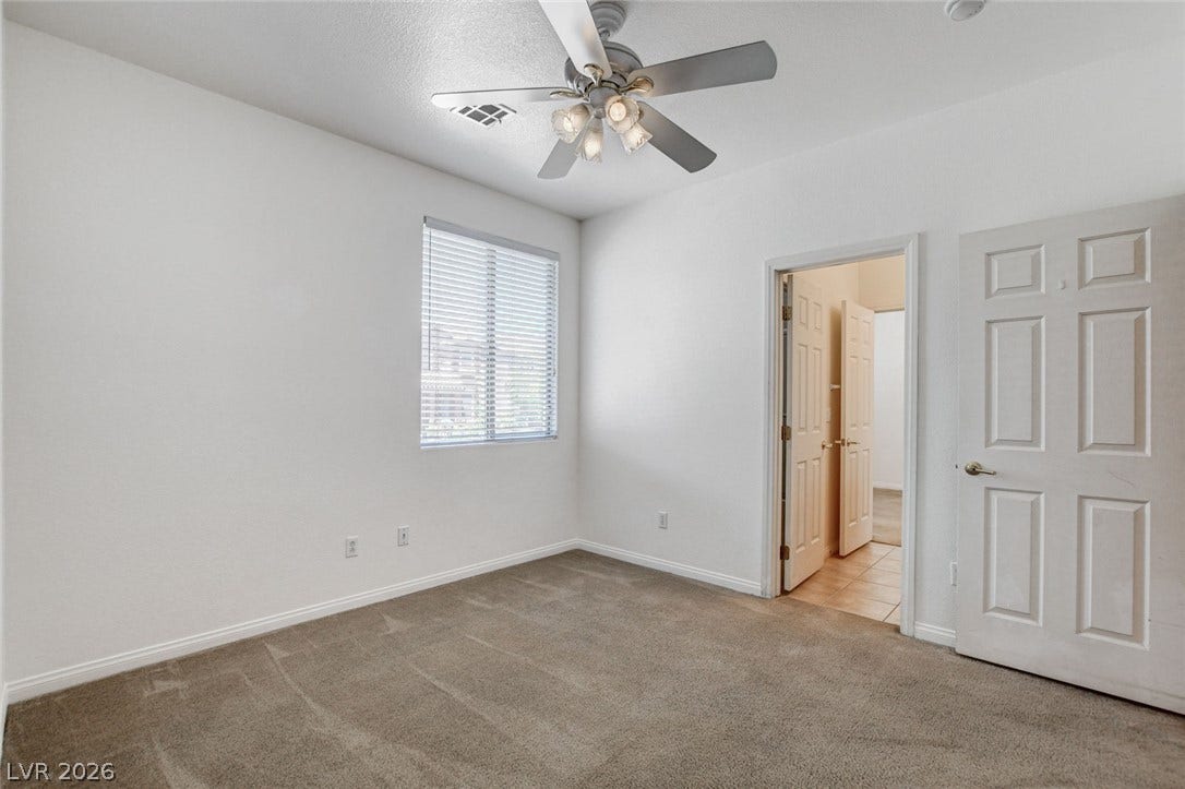 849 Ashford Way, Henderson, NV 89015 A well-lit bedroom with soft carpeting and a contemporary ceiling fan offers a comfortable personal retreat.