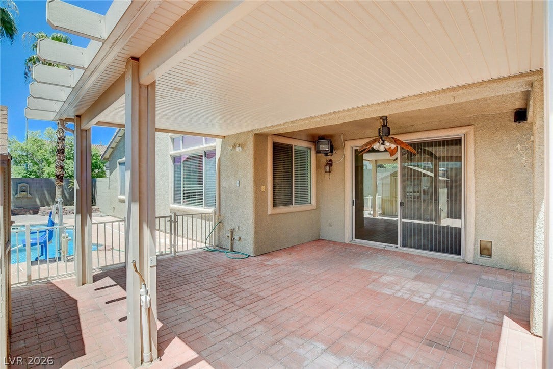 849 Ashford Way, Henderson, NV 89015 An inviting covered patio featuring brick pavers provides comfortable outdoor living space.