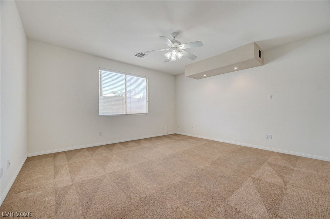 849 Ashford Way, Henderson, NV 89015 A spacious room offers comfortable carpet flooring and natural illumination through broad windows.