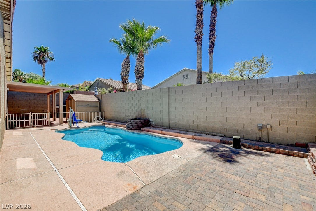849 Ashford Way, Henderson, NV 89015 Enjoy outdoor living with a sparkling pool and a cozy shaded patio area.