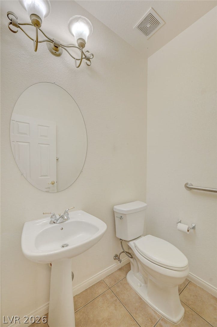 849 Ashford Way, Henderson, NV 89015 A pristine powder room features a pedestal sink and ceramic tile flooring.