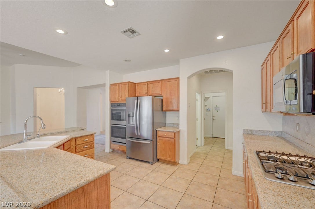 849 Ashford Way, Henderson, NV 89015 Culinary delights await in this well-appointed kitchen, featuring a gas range and ample counter space.