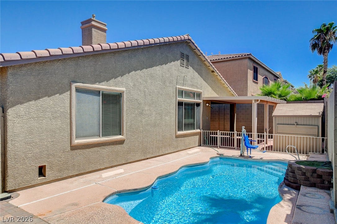 849 Ashford Way, Henderson, NV 89015 A private backyard oasis features a shimmering pool, covered patio, and practical storage shed.