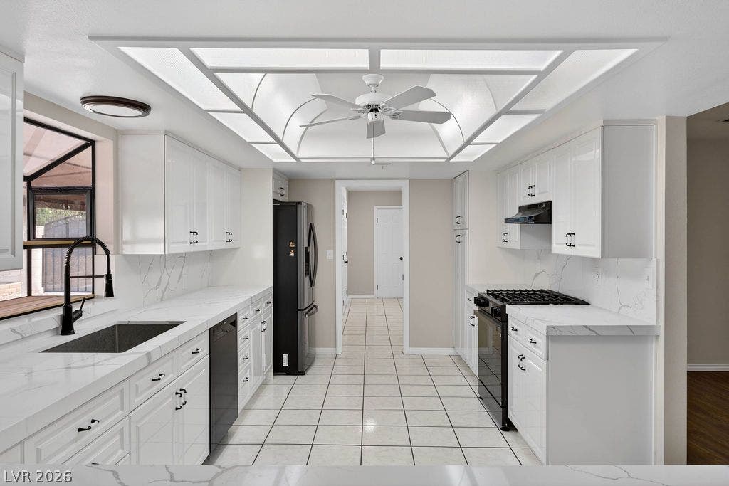 3189 Casanova Circle, Las Vegas, NV 89120 An illuminated tray ceiling and marble-patterned countertops define this sleek, modern kitchen space.