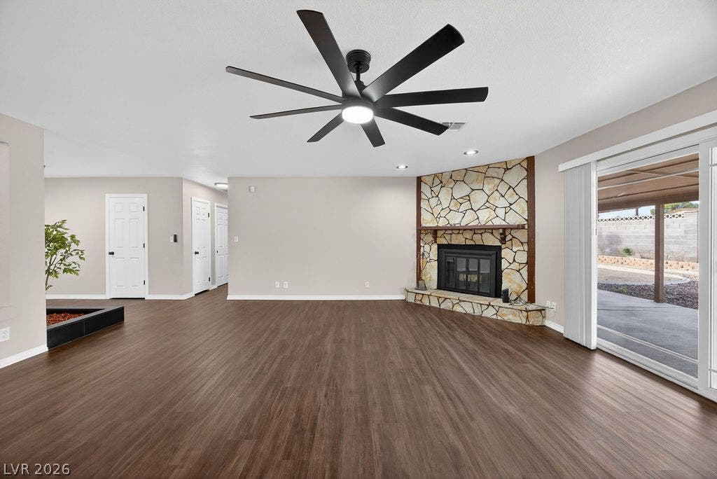 3189 Casanova Circle, Las Vegas, NV 89120 Rich wood-look flooring and a stone fireplace anchor this open living area.