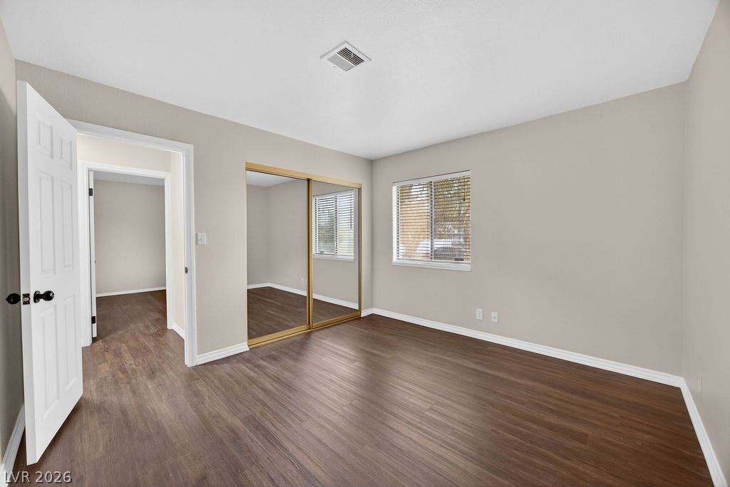 3189 Casanova Circle, Las Vegas, NV 89120 Gleaming wood floors and a mirrored closet define this serene secondary bedroom space.