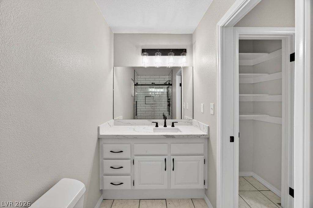 3189 Casanova Circle, Las Vegas, NV 89120 Guest 3/4 Bathroom Clean lines and stone counters highlight this updated bathroom with an adjacent walk-in closet.