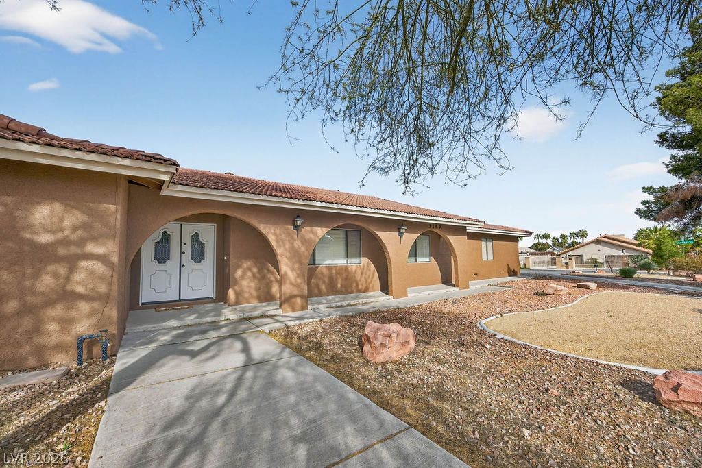 3189 Casanova Circle, Las Vegas, NV 89120 Distinctive arched entryways and a low-maintenance desert landscape welcome guests along the concrete walkway.